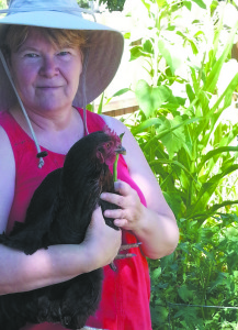 Vikki Walton with one of her chickens in her homestead.